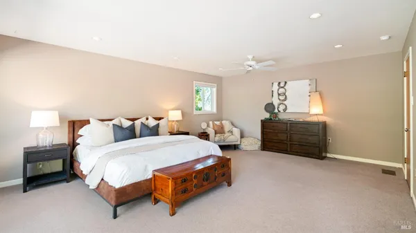 a bedroom with a bed chair and window