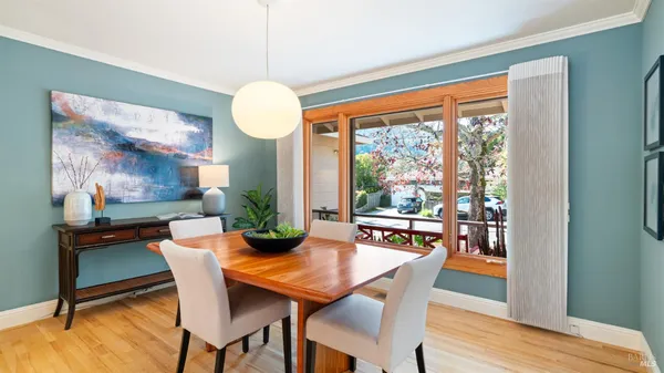 a living room with furniture dining table and a large window
