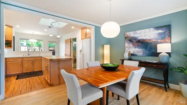 a kitchen with a sink a center island cabinets and wooden floor