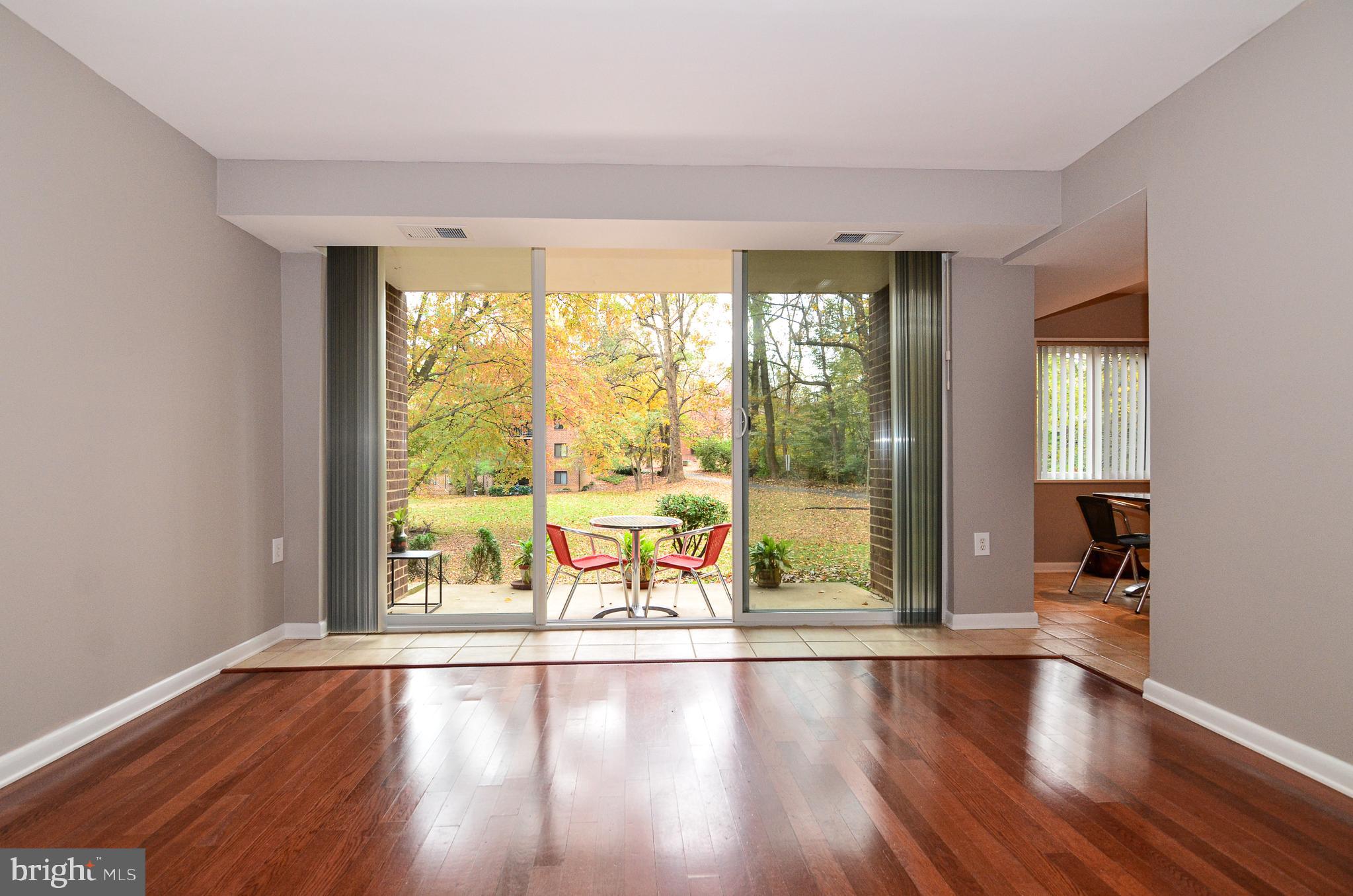1406 Northgate Square, Unit 1A Reston, VA 20190 - Photo 11 of 38 Living room opens to quiet patio