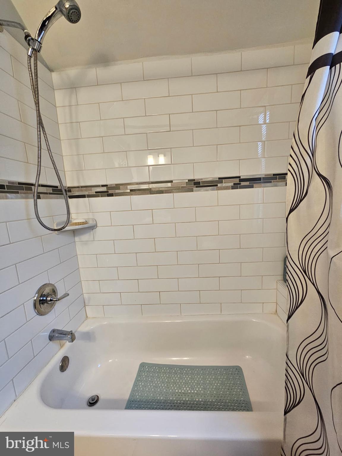 3911 4th Street Baltimore, MD 21225 - Photo 17 of 18 a bathroom with a bathtub and shower