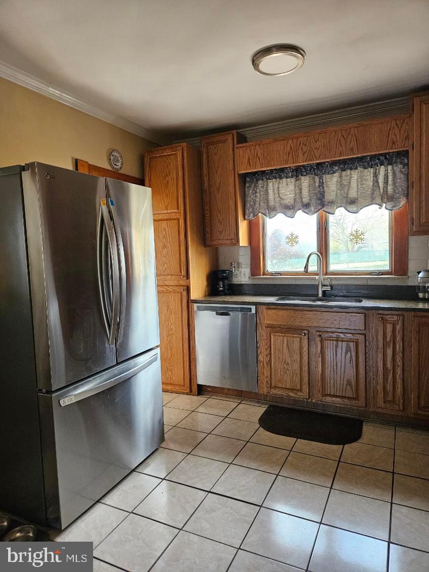 3911 4th Street Baltimore, MD 21225 - Photo 7 of 18 a kitchen with granite countertop a refrigerator and a sink