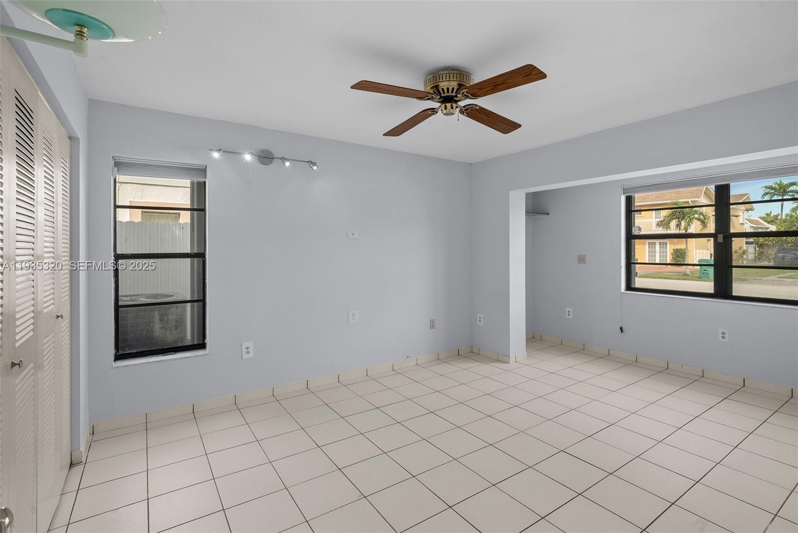 10922 Southwest 25th Street Miami, FL 33165 - Photo 13 of 33 a view of an empty room and window