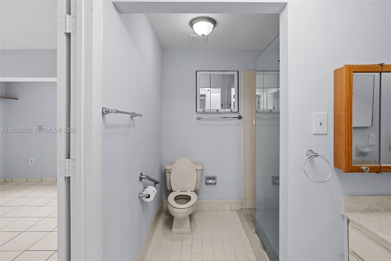 10922 Southwest 25th Street Miami, FL 33165 - Photo 15 of 33 a bathroom with a toilet and a shower