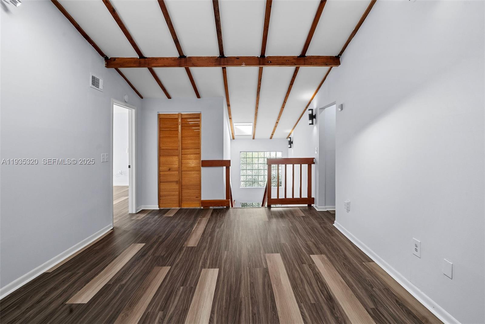 10922 Southwest 25th Street Miami, FL 33165 - Photo 16 of 33 a view of empty room with wooden floor and fan