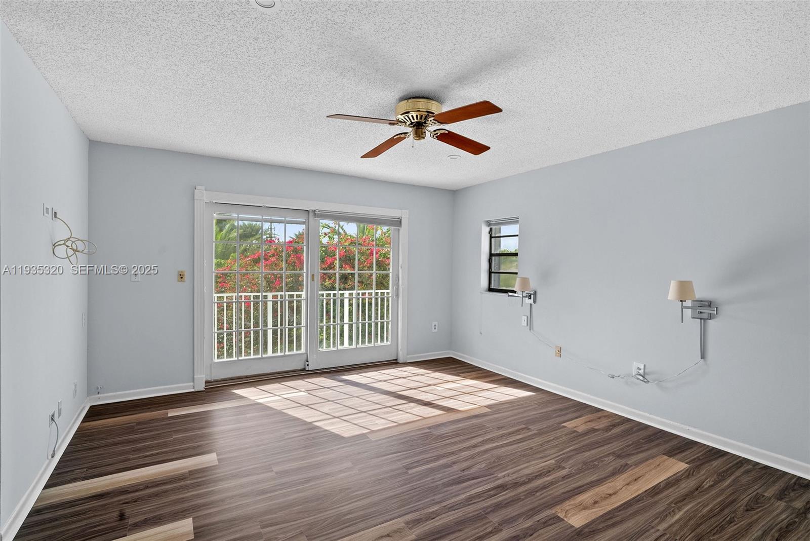 10922 Southwest 25th Street Miami, FL 33165 - Photo 18 of 33 a view of empty room with wooden floor and fan