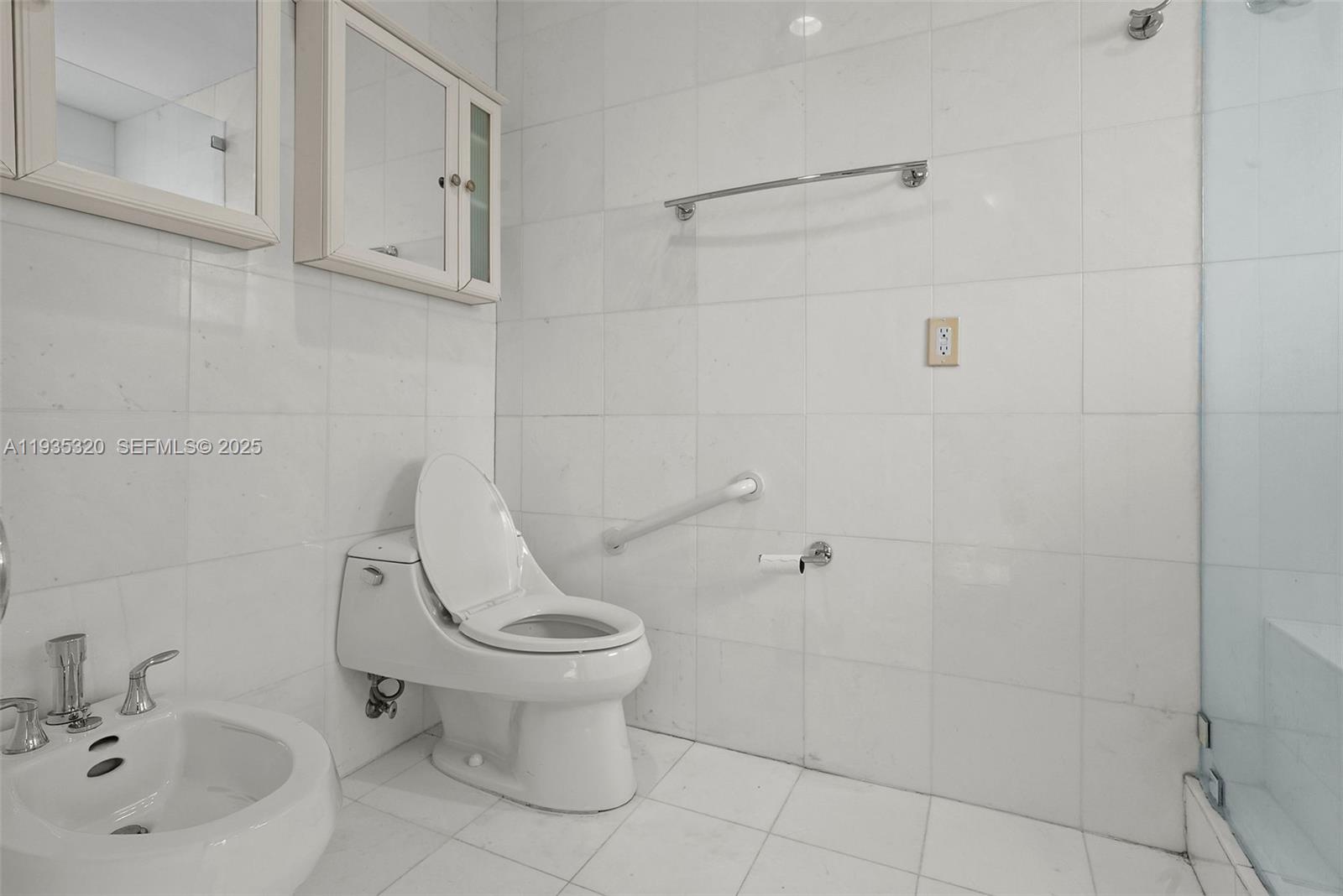 10922 Southwest 25th Street Miami, FL 33165 - Photo 21 of 33 a white toilet sitting next to a bathroom sink