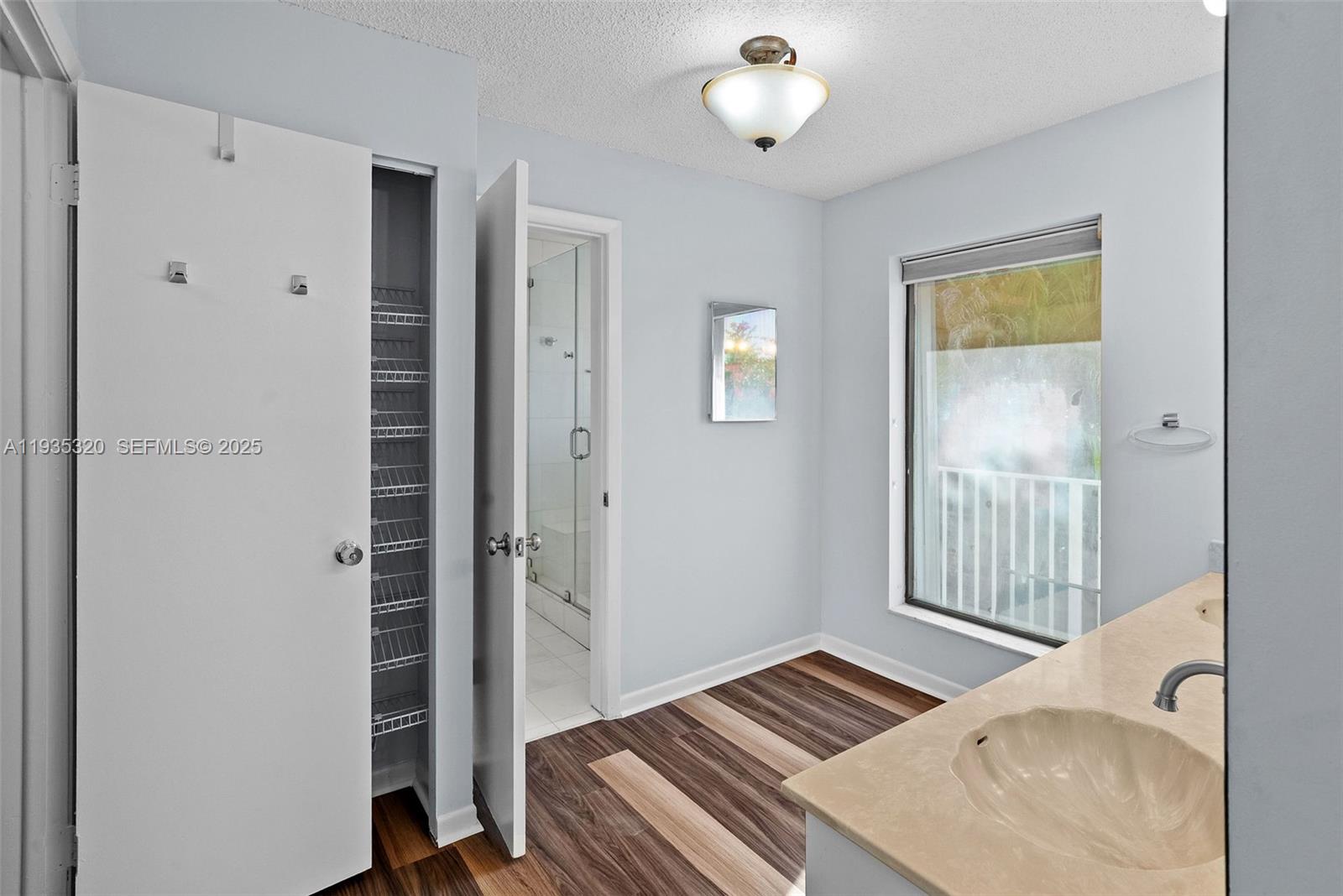 10922 Southwest 25th Street Miami, FL 33165 - Photo 22 of 33 a bedroom with a bed and a window