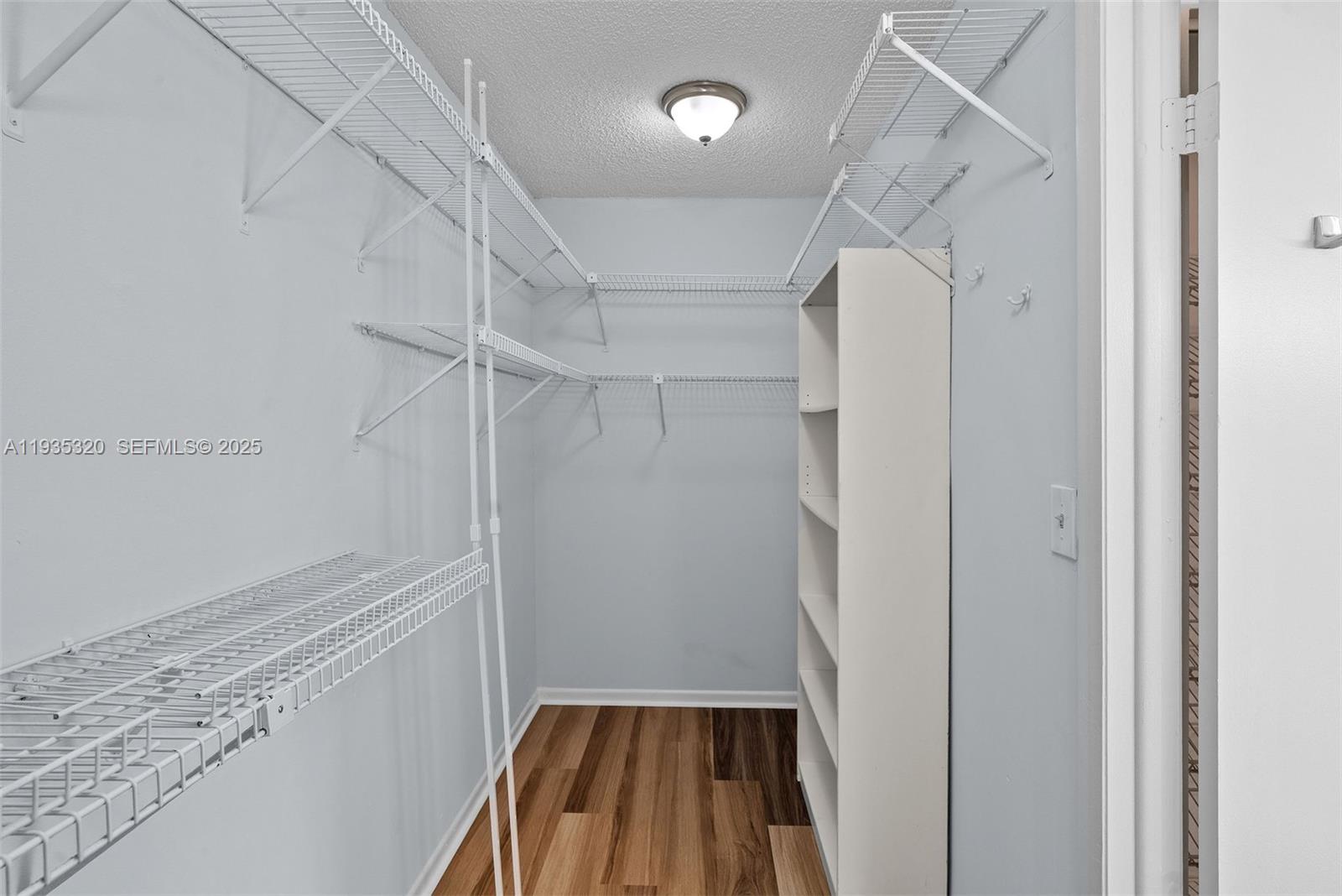 10922 Southwest 25th Street Miami, FL 33165 - Photo 23 of 33 a view of walk in closet with empty racks