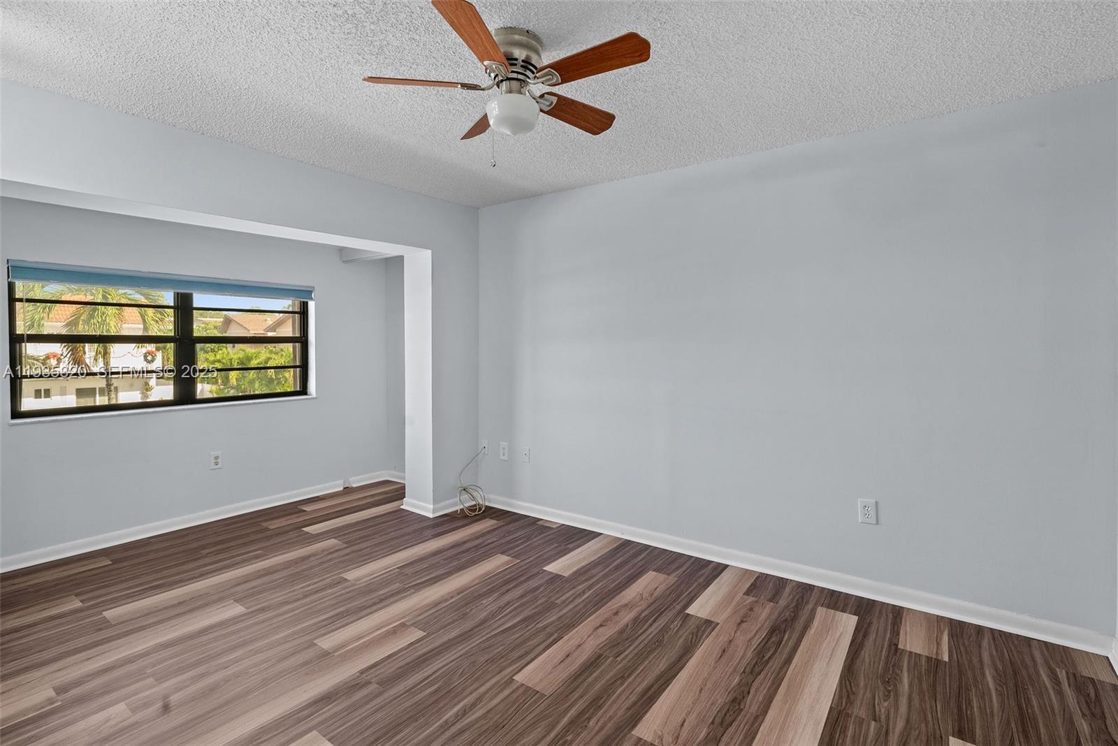 10922 Southwest 25th Street Miami, FL 33165 - Photo 24 of 33 wooden floor in an empty room with a window