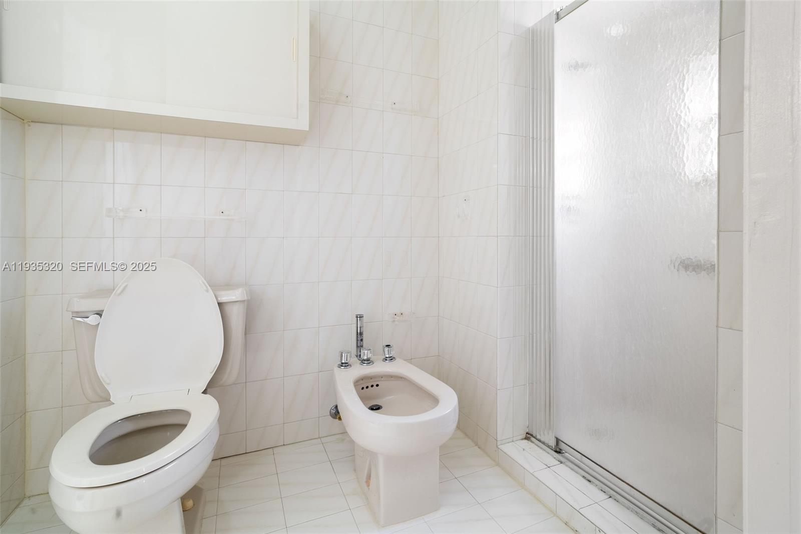 10922 Southwest 25th Street Miami, FL 33165 - Photo 27 of 33 a bathroom with a toilet and a sink