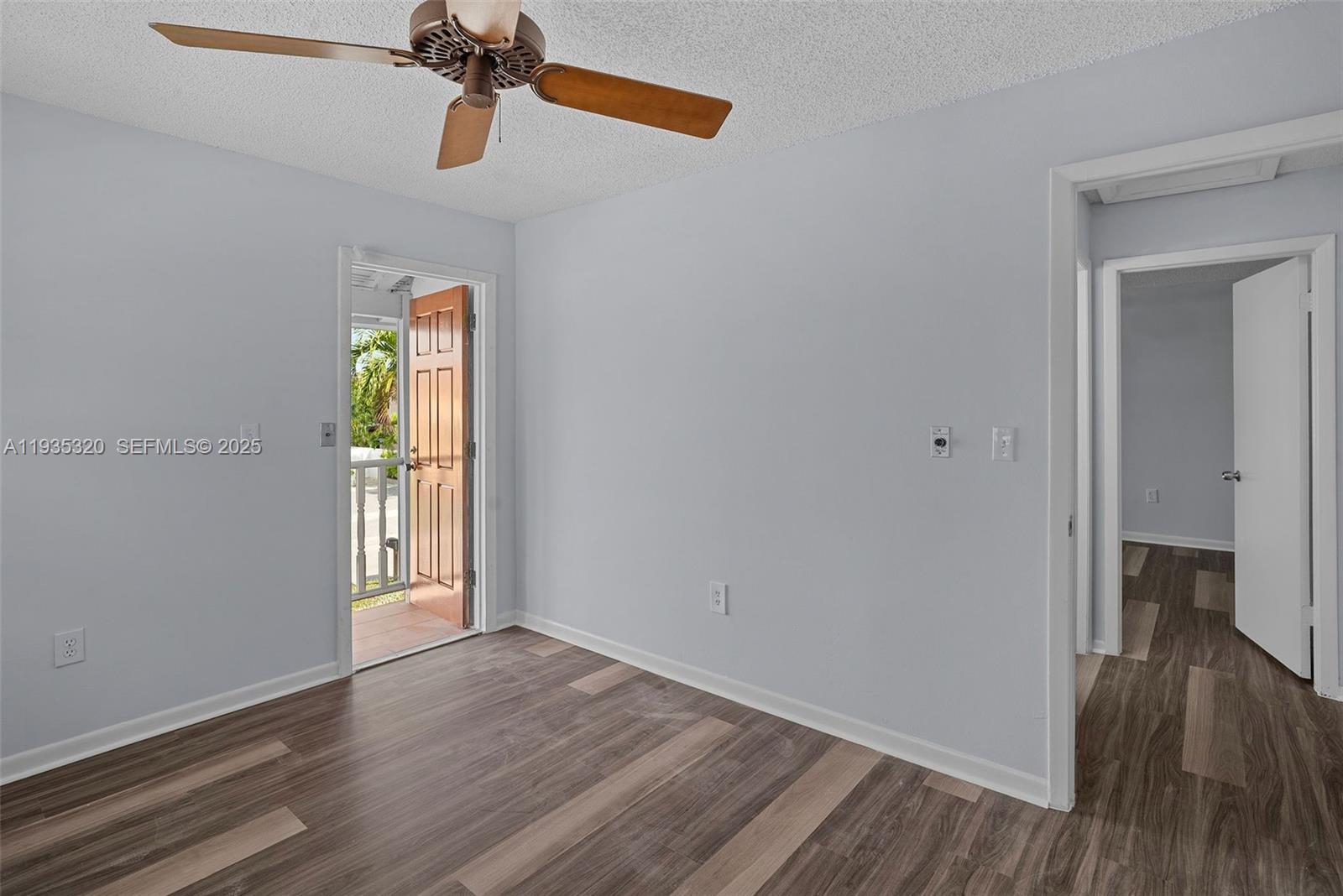 10922 Southwest 25th Street Miami, FL 33165 - Photo 29 of 33 a view of empty room with wooden floor and fan