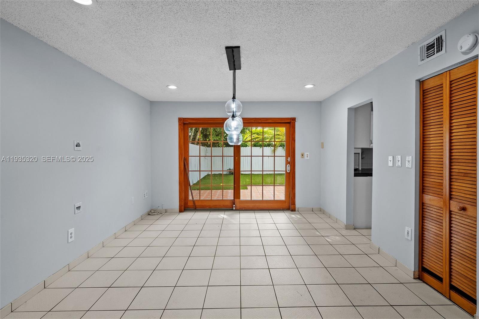 10922 Southwest 25th Street Miami, FL 33165 - Photo 5 of 33 a view of an empty room with window and chandelier