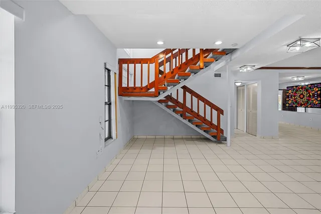 a kitchen with a refrigerator and a sink