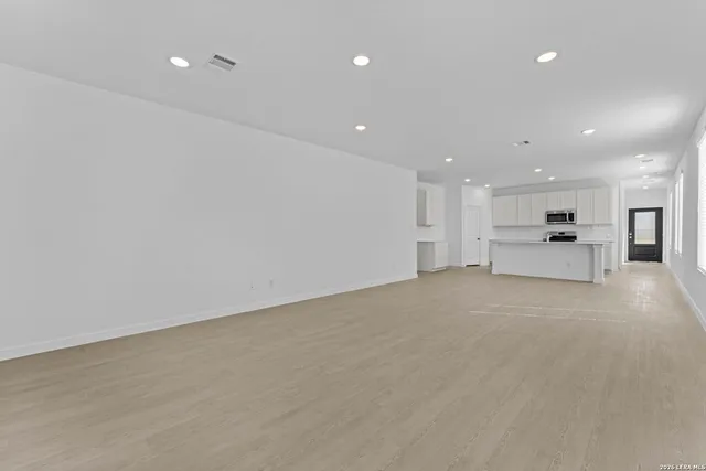 a view of kitchen with refrigerator and a fireplace