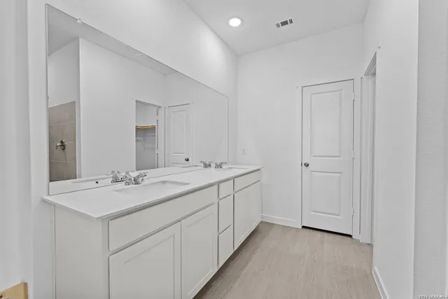 a bathroom with 2 sink and a mirror