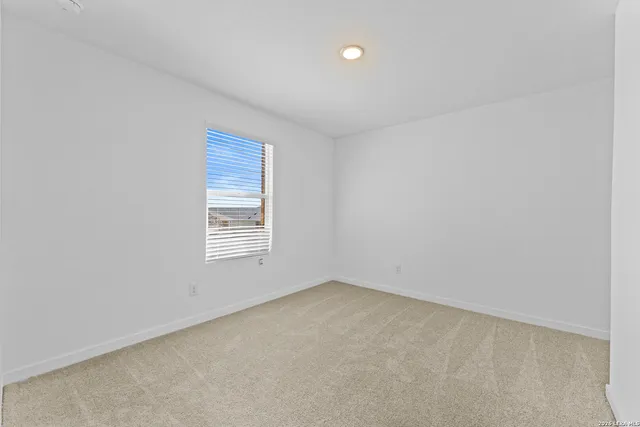 a front view of a house with plants and garden