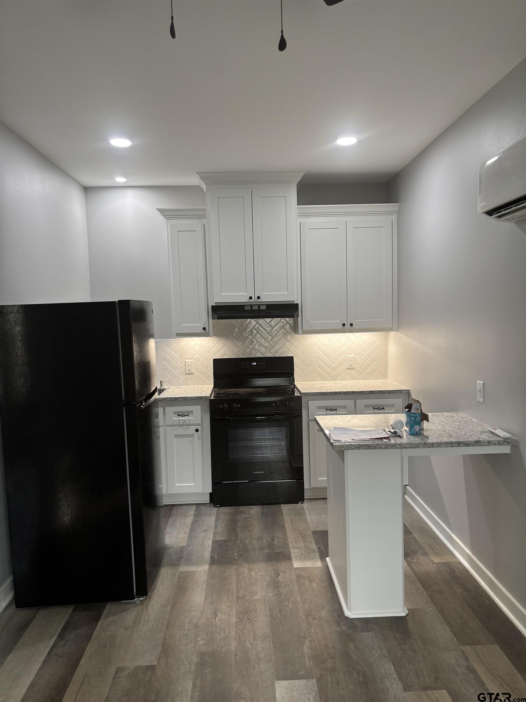 11571 19th Avenue, Unit 102 Tyler, TX 75708 - Photo 1 of 4 a kitchen with a stove a refrigerator and a sink