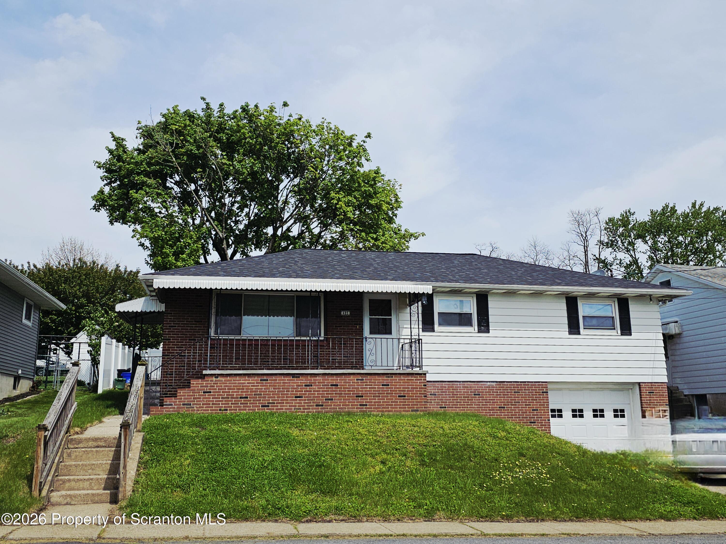 405 Baker Street Taylor, PA 18517 - Photo 1 of 36 a front view of a house with a yard