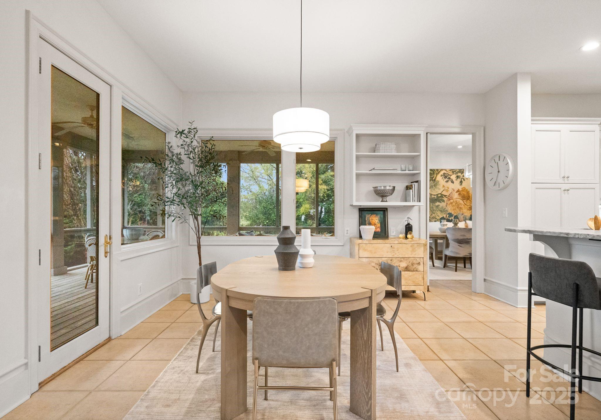 8813 Covey Rise Court Charlotte, NC 28226 - Photo 11 of 47 a dining room with wooden floor a glass table and chairs