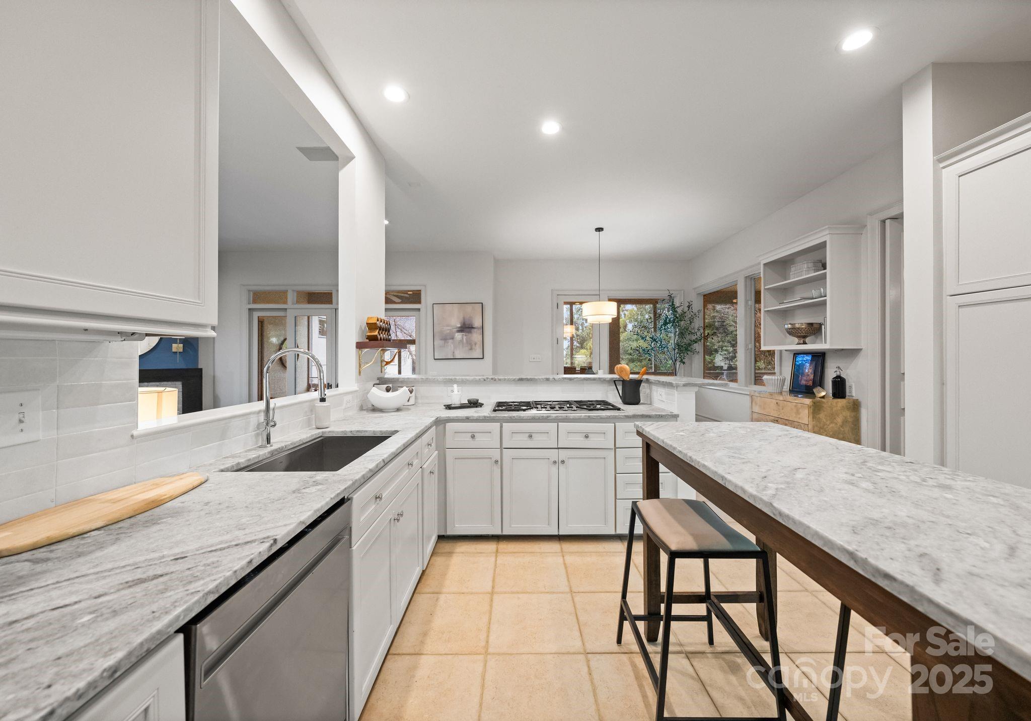 8813 Covey Rise Court Charlotte, NC 28226 - Photo 15 of 47 a kitchen with granite countertop lots of counter top space and dining table