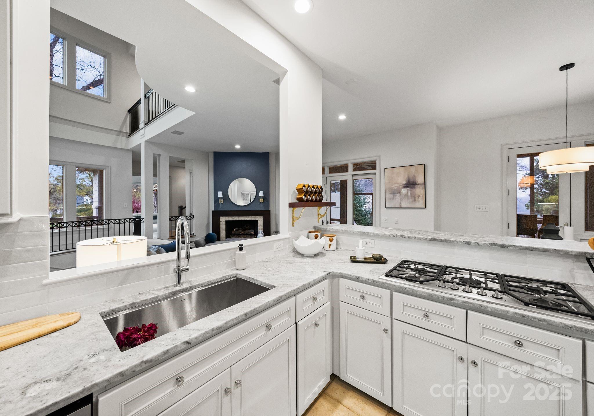 8813 Covey Rise Court Charlotte, NC 28226 - Photo 16 of 47 a kitchen with a sink and stove