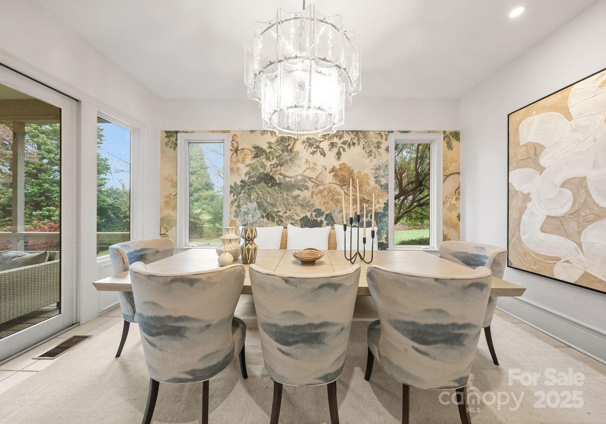 8813 Covey Rise Court Charlotte, NC 28226 - Photo 17 of 47 a dining room with furniture a chandelier and wooden floor
