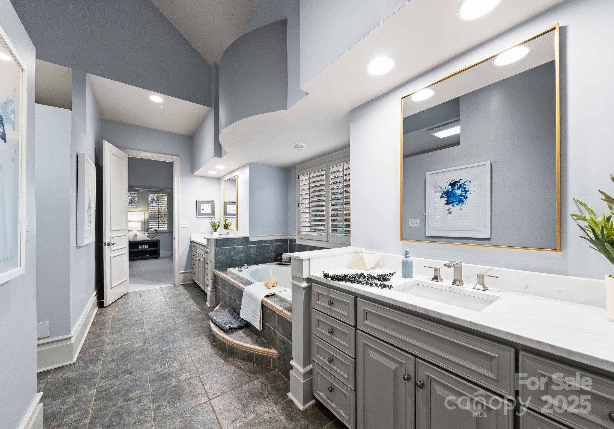 8813 Covey Rise Court Charlotte, NC 28226 - Photo 26 of 47 a en suite bathroom with a double vanity sink a mirror and a shower