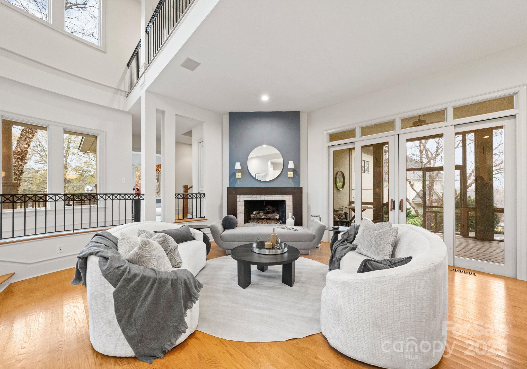 8813 Covey Rise Court Charlotte, NC 28226 - Photo 8 of 47 a living room with fireplace furniture and a large window