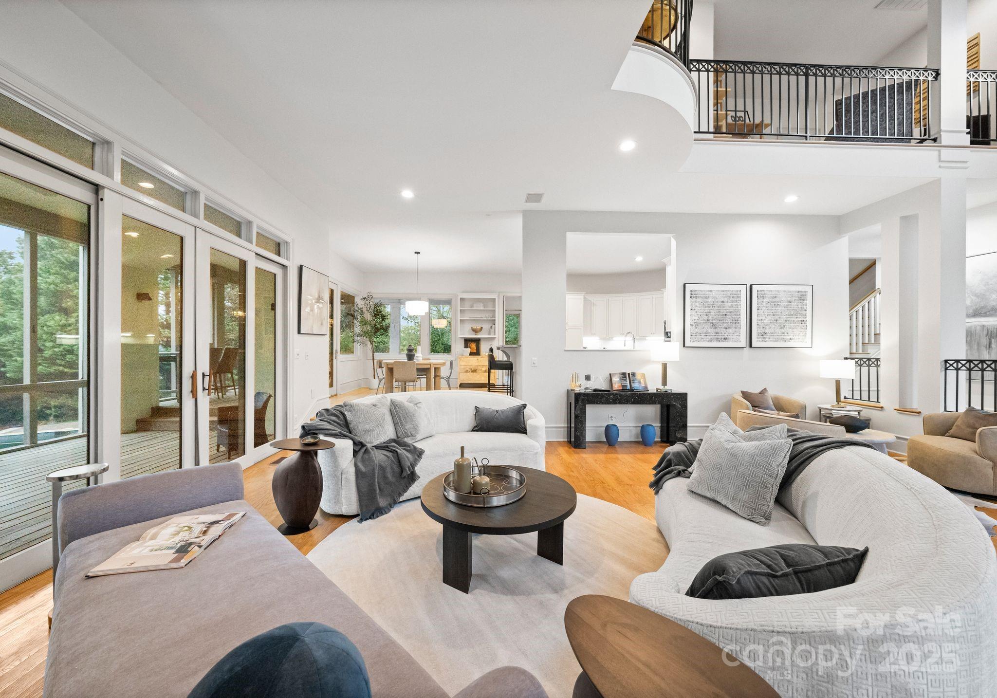 8813 Covey Rise Court Charlotte, NC 28226 - Photo 10 of 47 a living room with furniture large windows and wooden floor