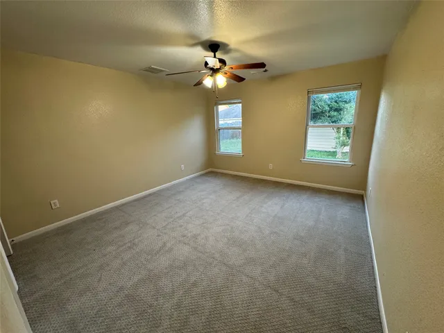 a view of room with window and ceiling fan