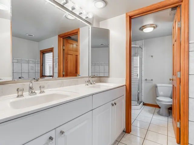 a bathroom with a sink a toilet and a mirror