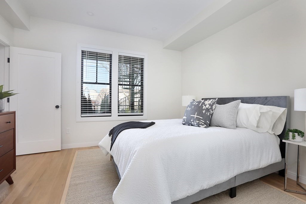 41 Summit Avenue, Unit 41 Brookline, MA 02446 - Photo 12 of 20 a bedroom with a large bed and a large window