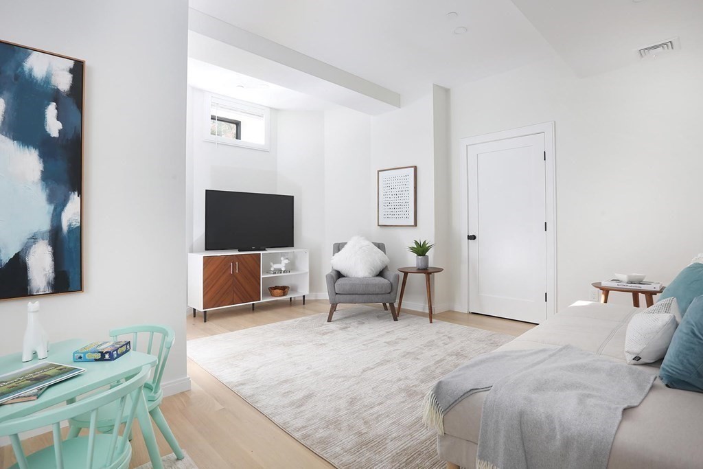 41 Summit Avenue, Unit 41 Brookline, MA 02446 - Photo 15 of 20 a bedroom with a bed and a couch