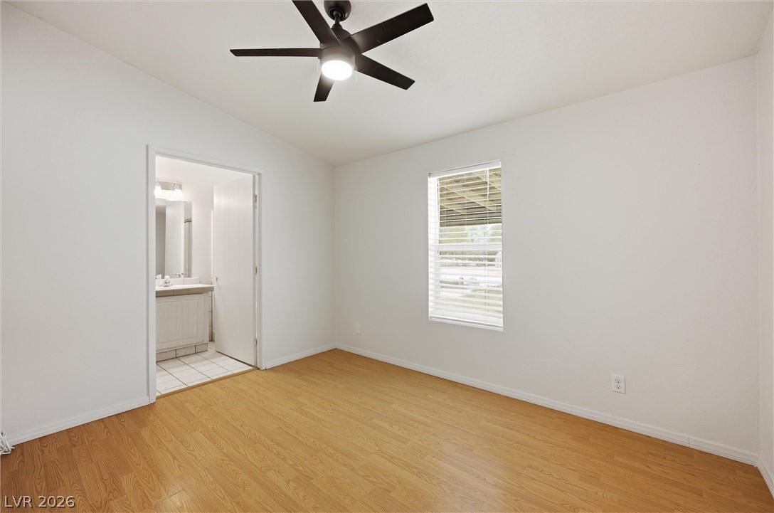 1531 West Harris Farm Road Pahrump, NV 89060 - Photo 27 of 37 Well-lit living area features attractive hardwood flooring and a ceiling fan for comfort.