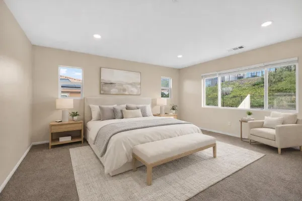 a spacious bedroom with a bed and glass window