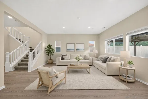 a living room with fireplace furniture and a potted plant