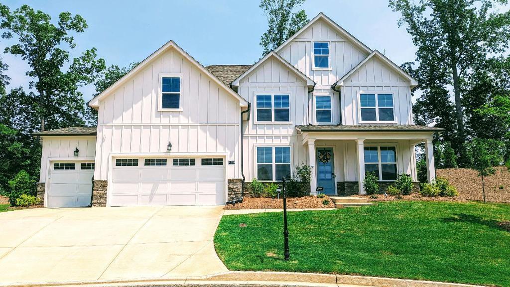 4830 Spangle Court Cumming, GA 30028 - Photo 1 of 18 a view of a yard in front of a brick house with a large windows