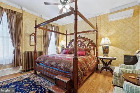 a view of a kitchen area with furniture and wooden floor