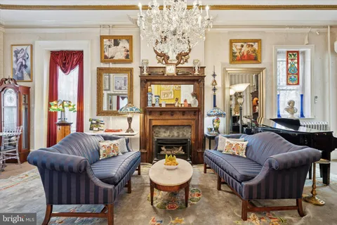 a living room with furniture and a chandelier