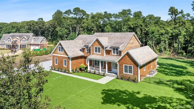an aerial view of a house with swimming pool next to a big yard