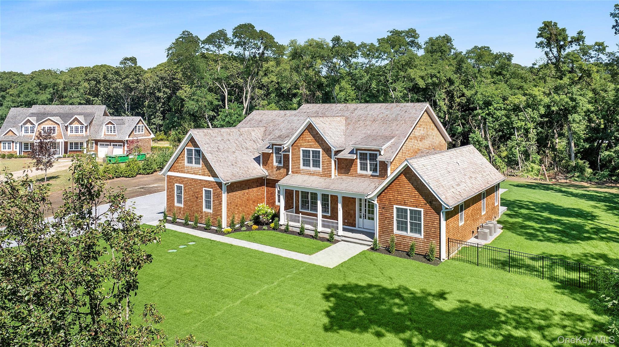 an aerial view of a house with swimming pool next to a big yard