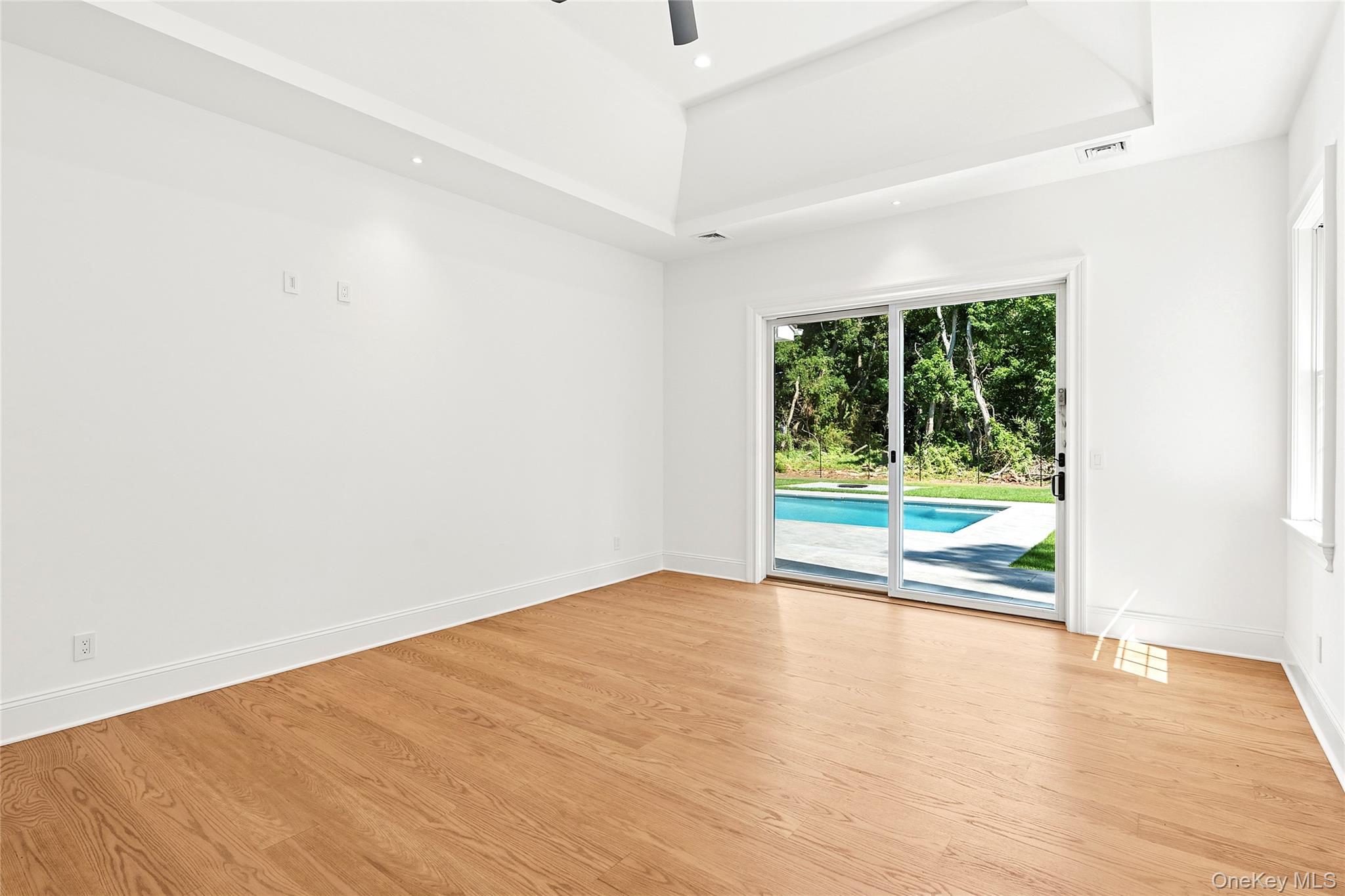 80 Deer Run Southold, NY 11971 - Photo 14 of 29 an empty room with wooden floor and windows