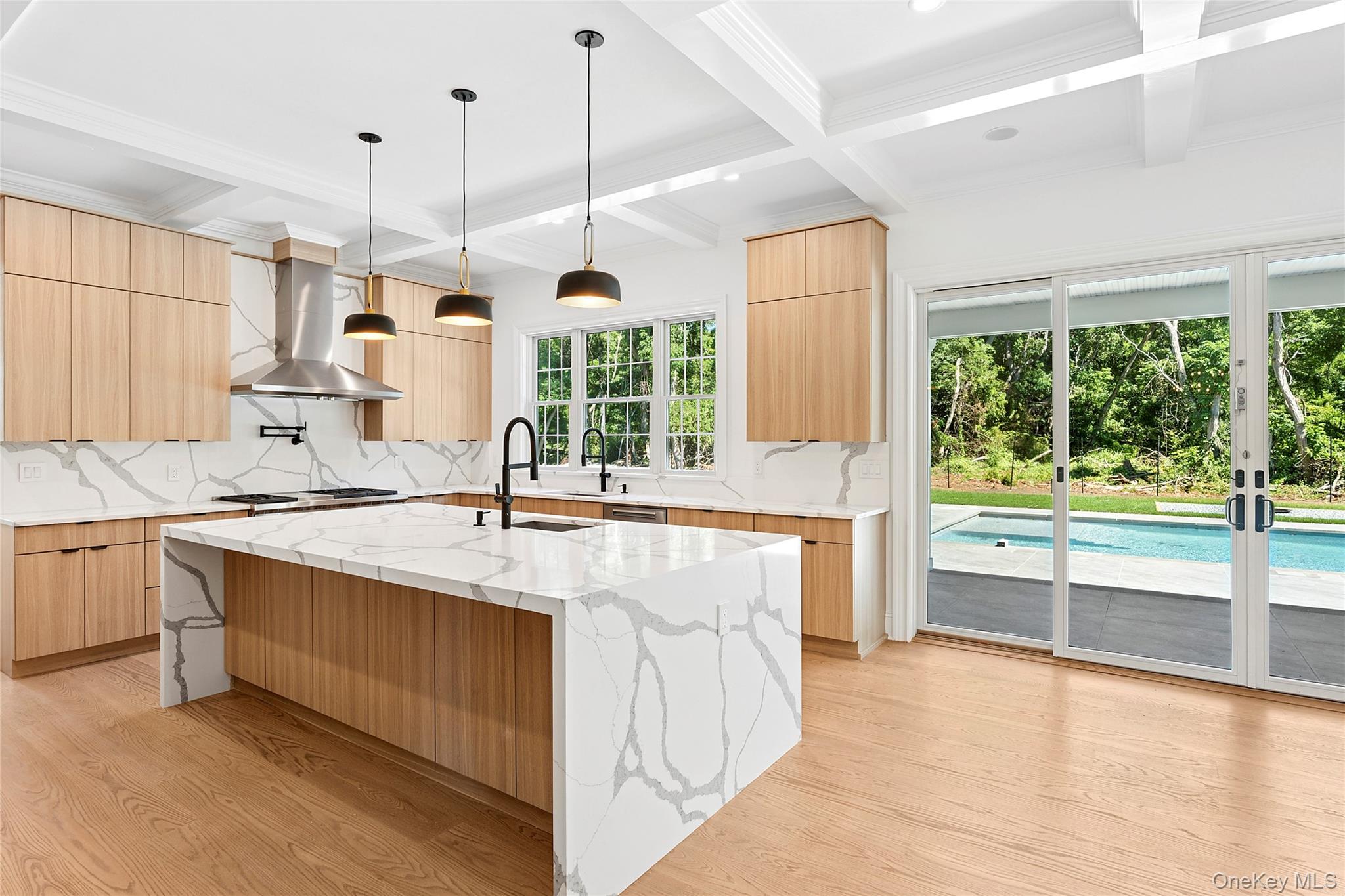 80 Deer Run Southold, NY 11971 - Photo 9 of 29 a kitchen with stainless steel appliances granite countertop a sink a stove and a wooden floors