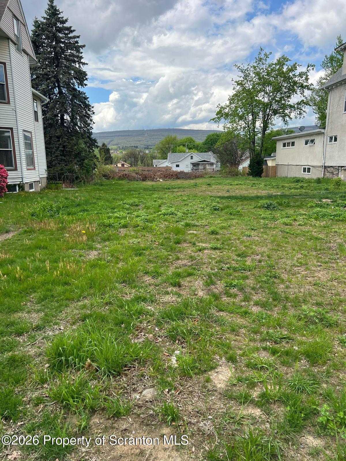 1635 Sanderson Avenue Scranton, PA 18509 - Photo 2 of 5 a view of a garden with a building in the background