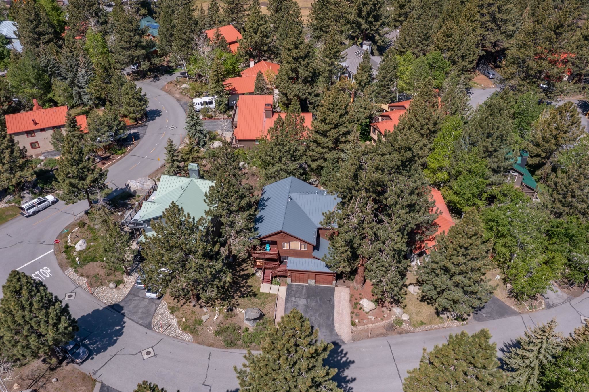 23 Trails End Road Mammoth Lakes, CA 93546 - Photo 56 of 58 Two-story property featuring a metal roof, wood-paneled exterior, and a two-car garage