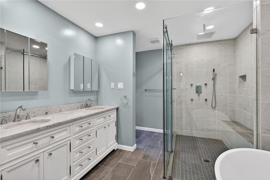 1371 Stoke Park Road Bethlehem, PA 18017 - Photo 33 of 55 a bathroom with a double vanity sink toilet mirror and windows
