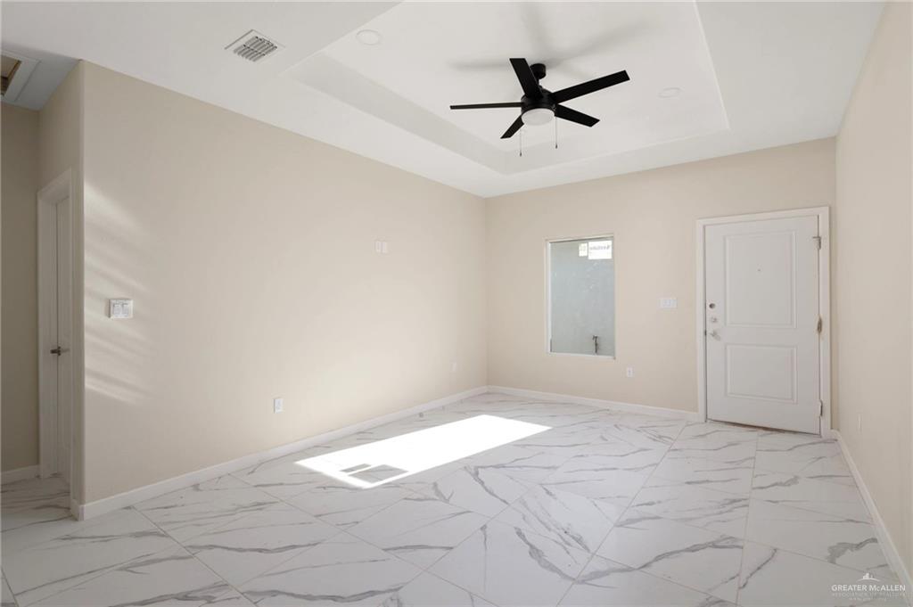 608 Mountain Road, Unit 9A Mission, TX 78573 - Photo 2 of 11 a view of a livingroom with a ceiling fan & window