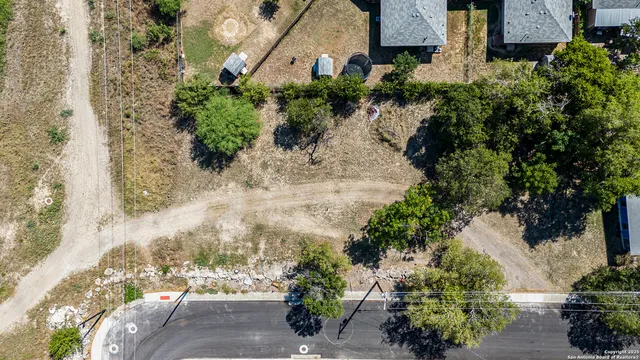 an aerial view of a house with a yard