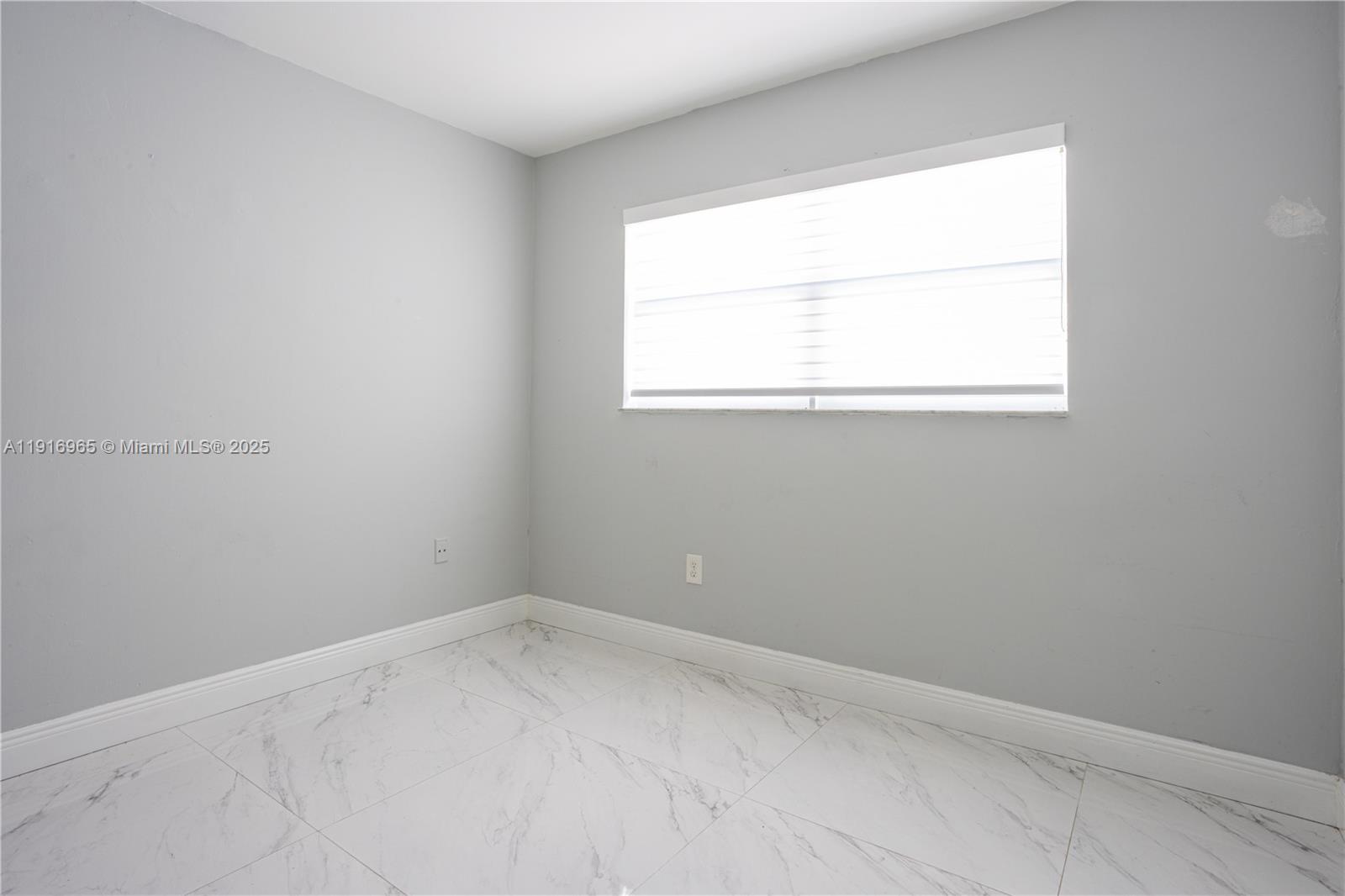 11510 Southwest 7th Street Sweetwater, FL 33174 - Photo 13 of 17 an empty room with a window